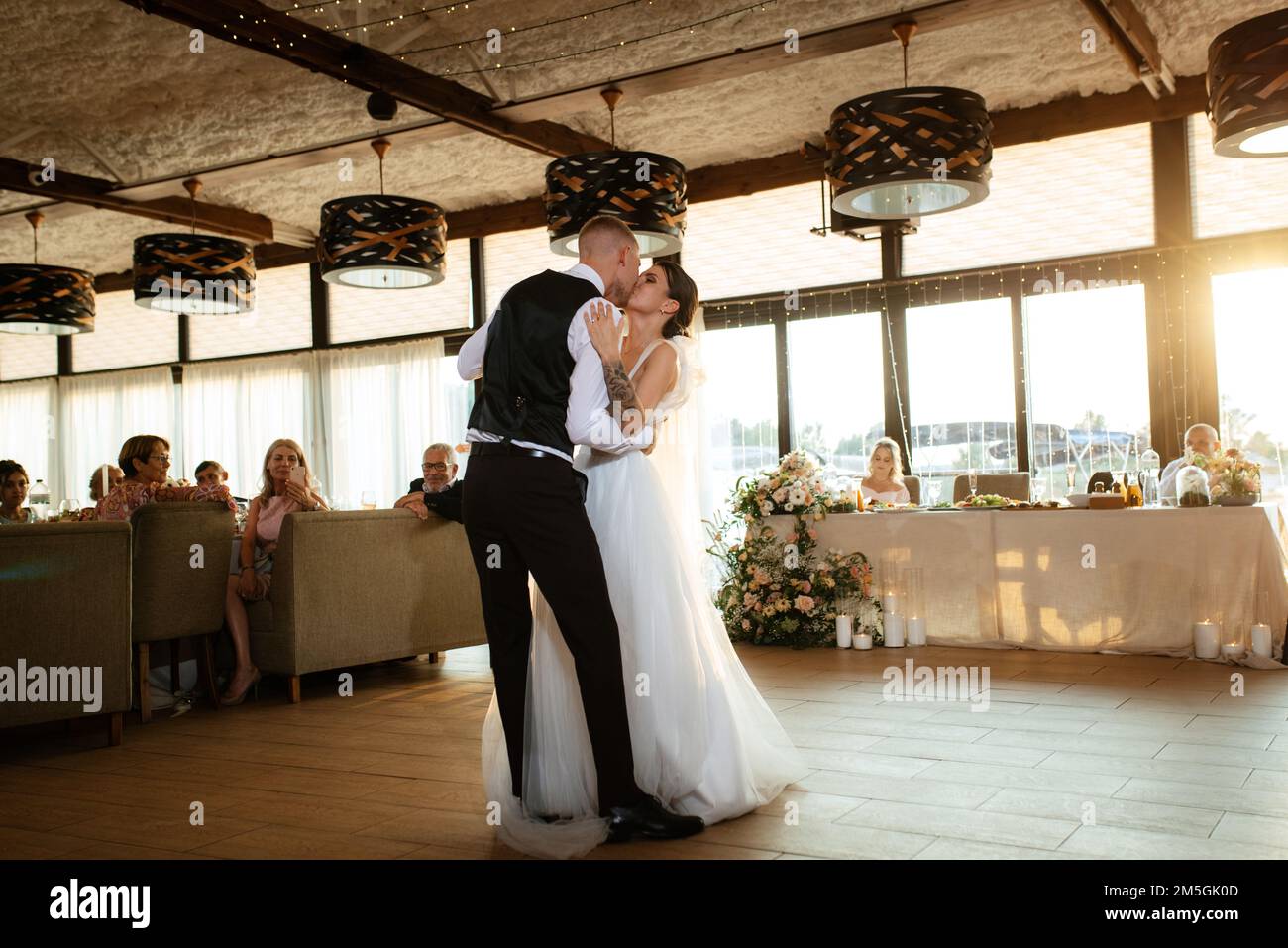 the first wedding dance of the bride and groom inside the restaurant