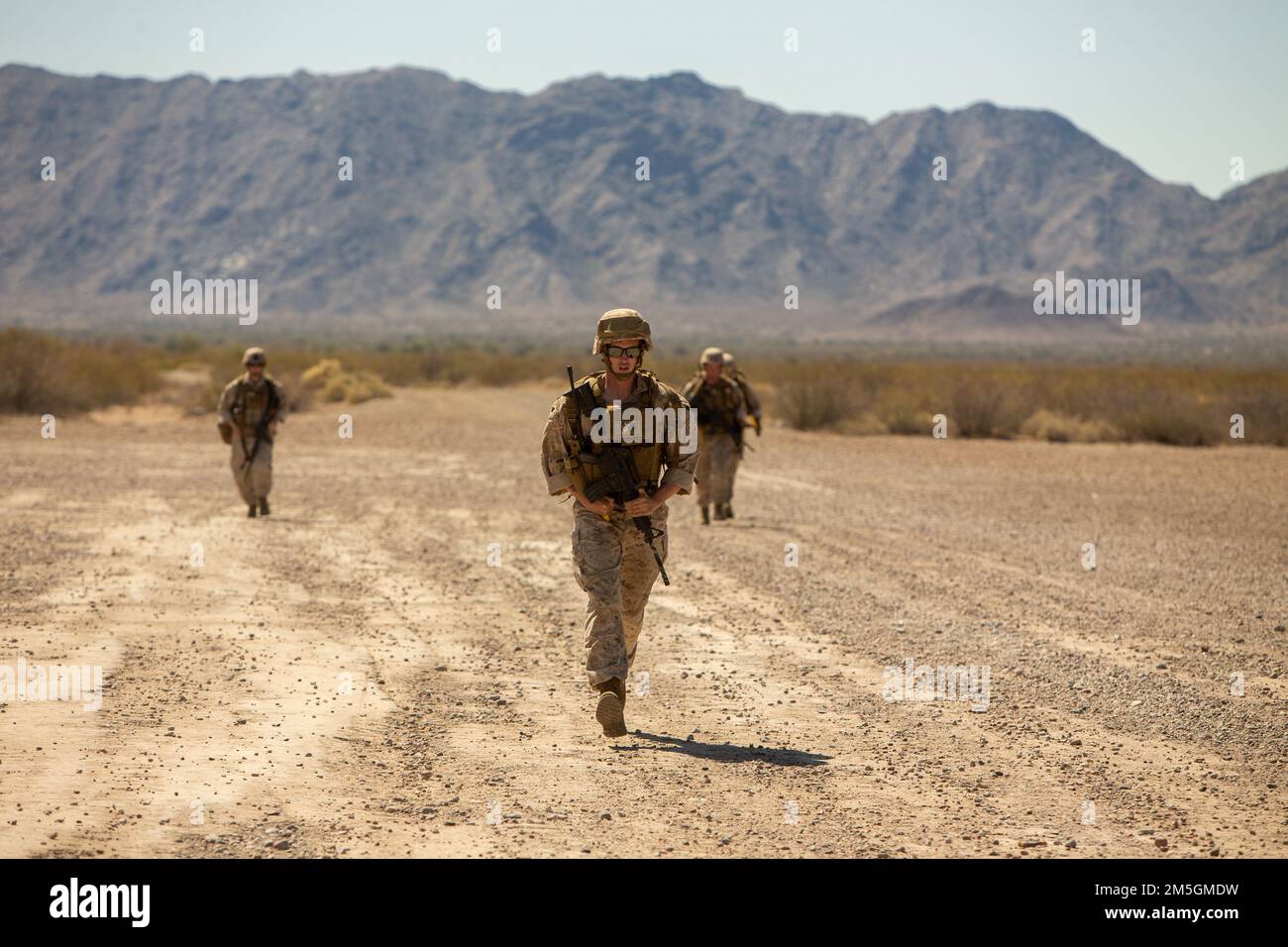 U.S. Marines assigned to Marine Air Traffic Control Mobile Team, Marine Aviation Weapons and Tactics Squadron One (MAWTS-1), run to their positions to execute Marine air traffic control mobile team simulations, during Weapons and Tactics Instructor (WTI) course 2-22, at Stoval Airfield, near Dateland, Arizona, March 17, 2022. WTI is a seven-week training event hosted by MAWTS-1, providing standardization advanced tactical training and certification of unit instructor qualifications to support Marine aviation training and readiness and assist in developing and employing aviation weapons and tac Stock Photo