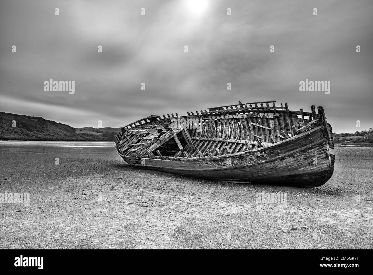 Wrecked wooden fishing boat on a Welsh beach Stock Photo