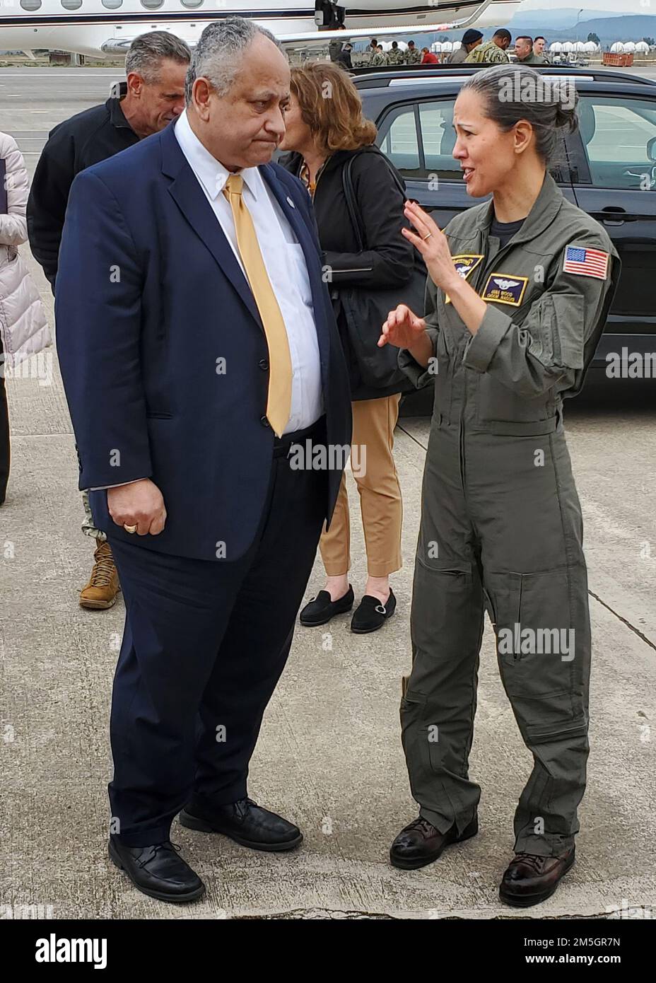 220317-N-OX321-2065 NAVAL AIR STATION SIGONELLA, Italy (March 17, 2022) – Secretary of the Navy Carlos Del Toro, left, speaks with Command Master Chief Anna Wood, Naval Air Station Sigonella command master chief, upon arrival to NAS Sigonella on March 17, 2022. NAS Sigonella’s strategic location enables U.S., allied, and partner nation forces to deploy and respond as required, ensuring security and stability in Europe, Africa, and Central Command. Stock Photo