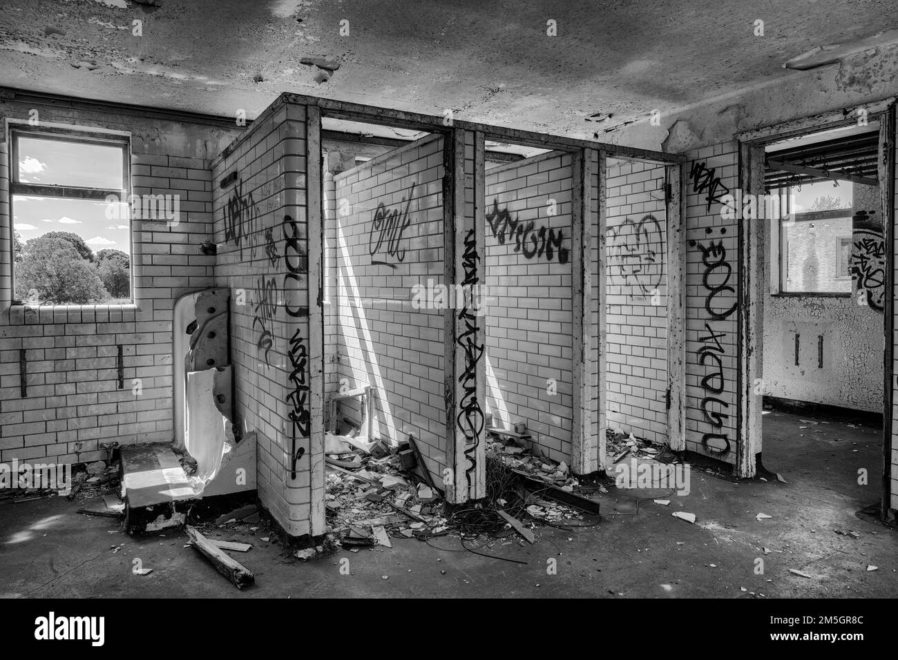 Vandalised toilet stalls in an abandoned building Stock Photo