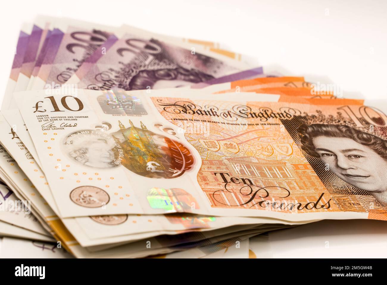 a few hundred pound of new GBP £ Sterling Twenty 20 and Ten 10 pound notes in a small fanned stack Stock Photo
