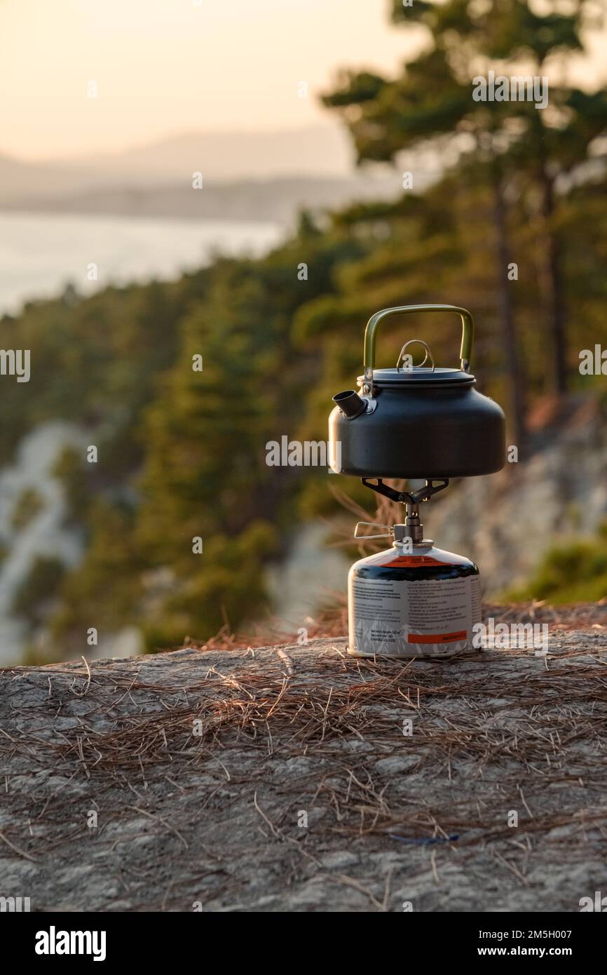 https://c8.alamy.com/comp/2M5H007/vintage-small-kettle-on-a-bonfire-on-a-mountain-meadow-during-a-bad-weather-making-coffee-or-tea-on-the-fire-travel-in-the-mountains-2M5H007.jpg