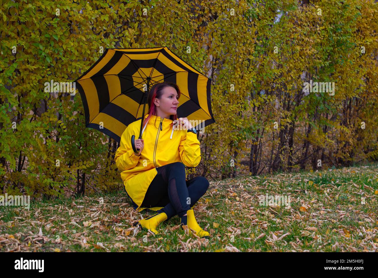 Beautiful girl in yellow raincoat hi-res stock photography and images ...