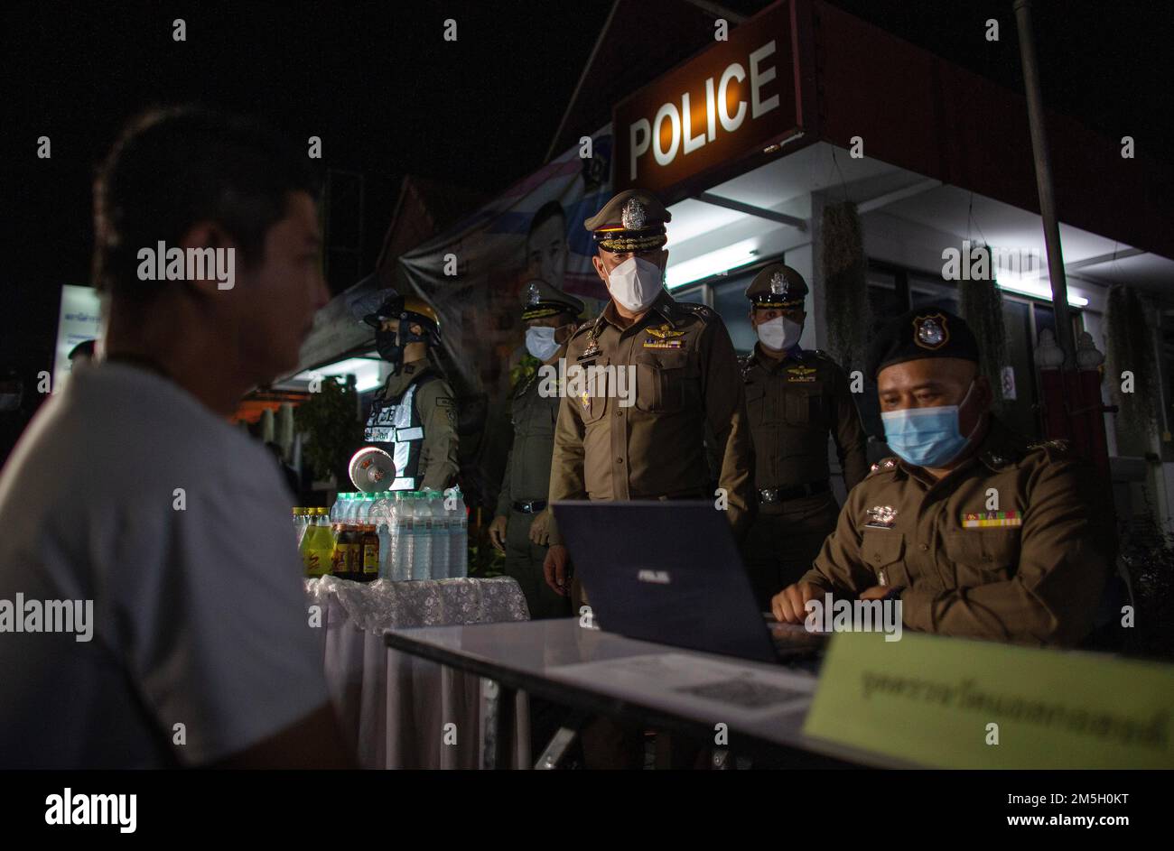 Thai police officers at Check point for alcohol tests via in Chiang Mai. The Center for Prevention and Reduction of Road Accidents has been established during the New Year's Festival 2023, the 7-day intensive control period from 29 December 2022 to 4 January 2023. More than 50,000 police officers are to set up checkpoints to facilitate traffic laws and take care of the safety of people. They will work throughout the festival without holidays, focusing on 4 charges according to government policy: driving while intoxicated, driving too fast, and not wearing a helmet. and a seat belt. In this reg Stock Photo