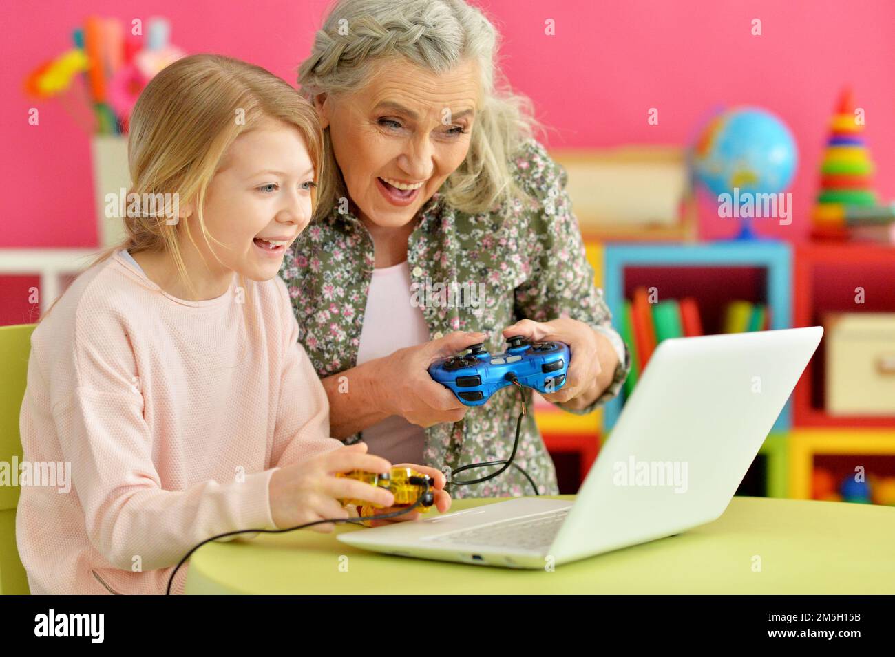 Preppy Grandma Using Computer granny with her granddaughter playing computer game Stock Photo - Alamy