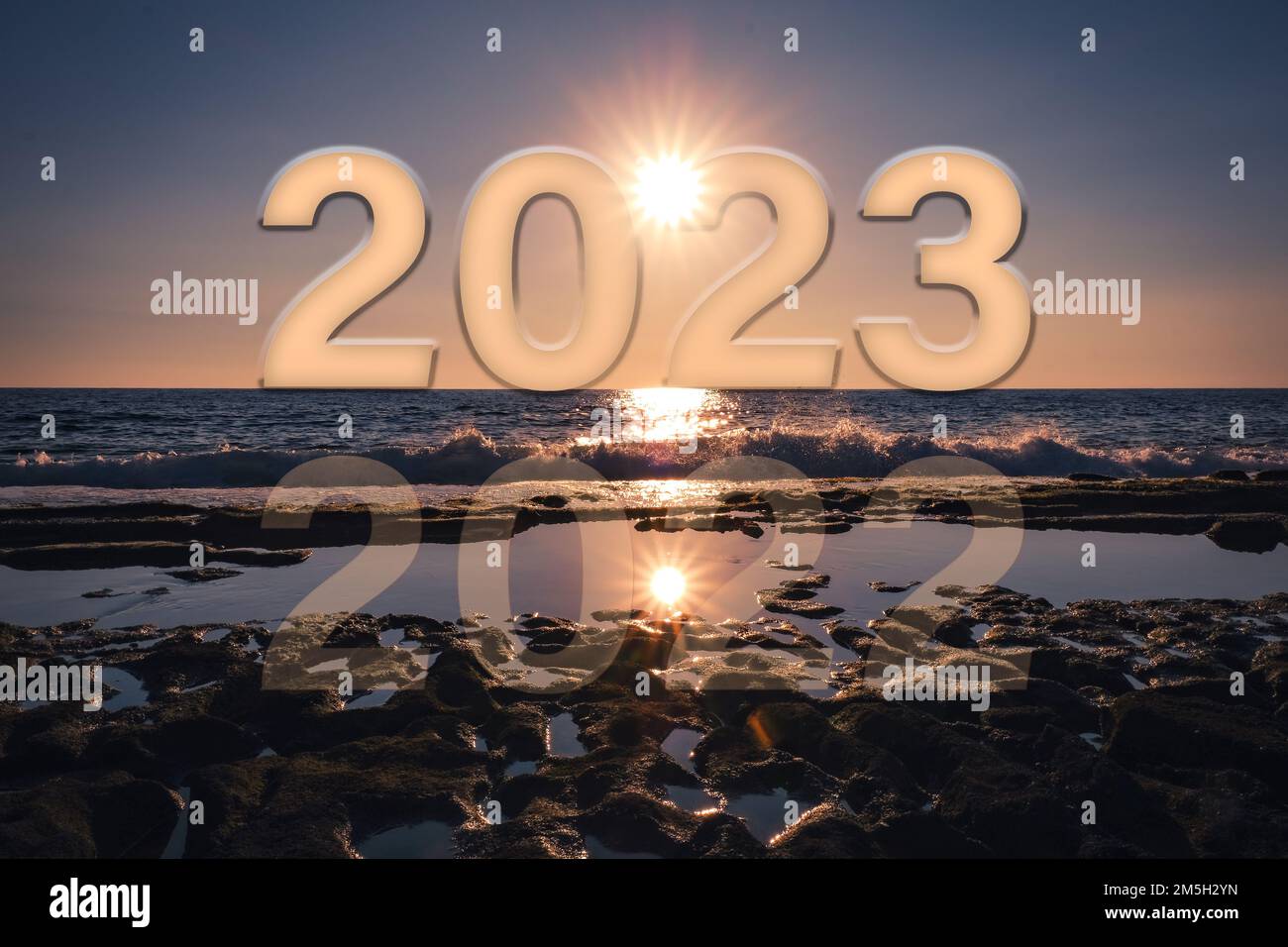 Happy new year 2023, holiday concept with sunset reflection at the beach. Copy Space Stock Photo