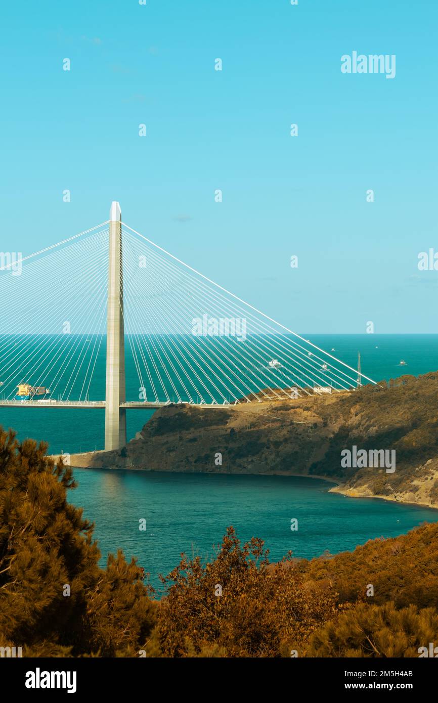 Yavuz Sultan Selim Bridge, the third bridge of Istanbul. Vertical photograph taken partially from the Anatolian side.  Blue sea and sky. No people. Stock Photo