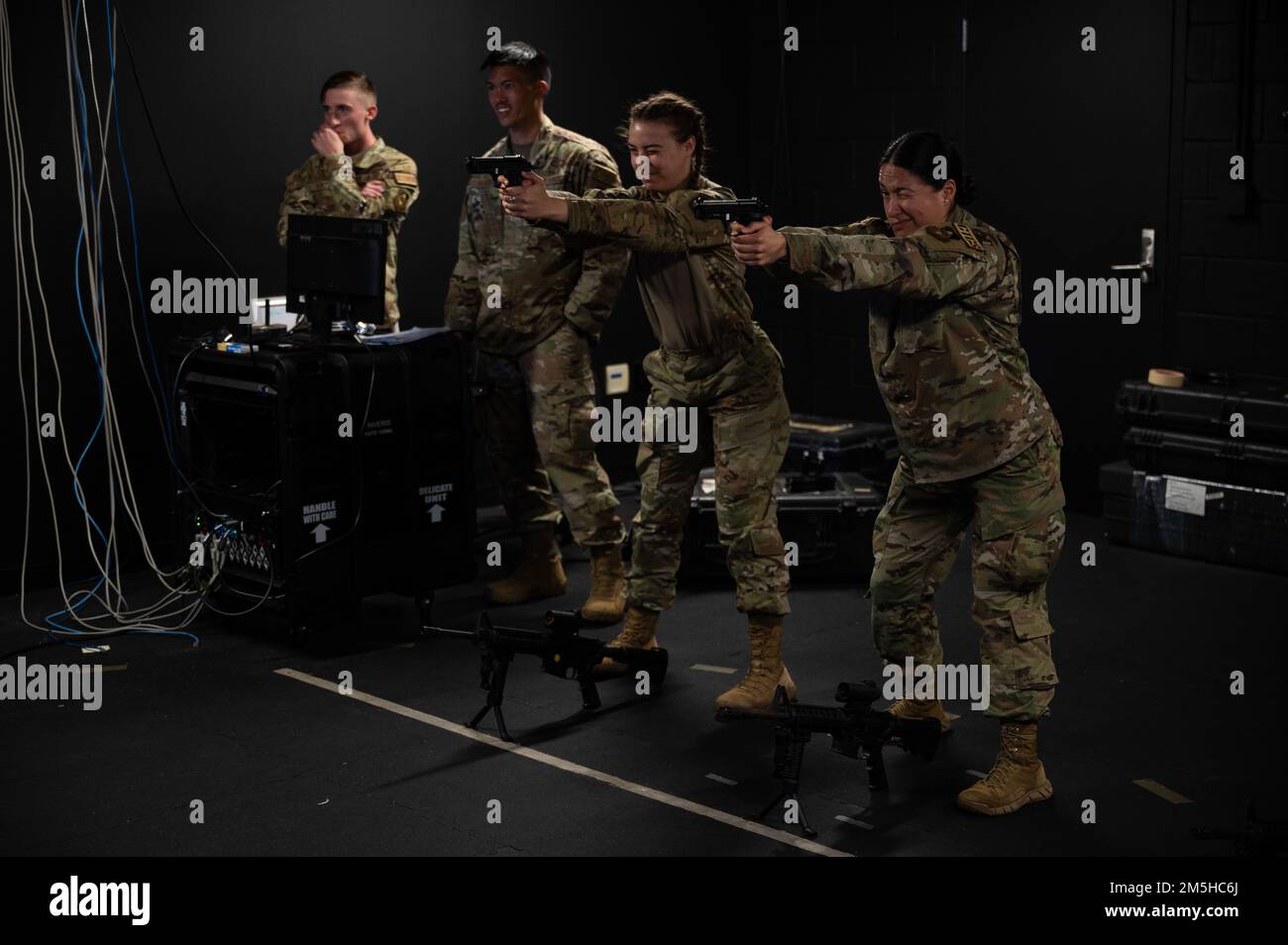 U.S. Air Force Airmen execute weapons simulation training during exercise Scorpion Lens at Joint Base Charleston, South Carolina, March 17, 2022. The 1st Combat Camera Squadron (1CTCS) holds Exercise Scorpion Lens annually to provide expeditionary skills training to Combat Camera Airmen. Stock Photo