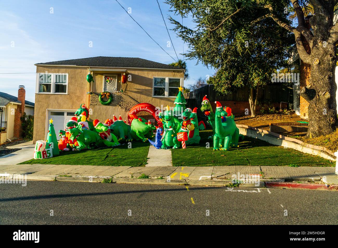 A house in San Leandro California on Christmas eave with an all Dinosaur front yard Stock Photo