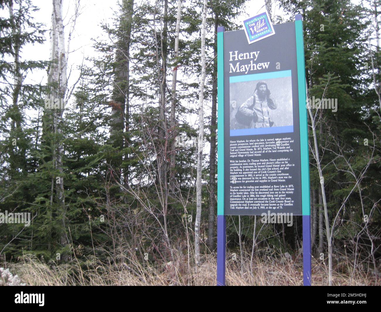 Gunflint Trail Scenic Byway - Mayhew Historic Site. The Henry Mayhew interpretive sign stands near a wildlife pond along the Gunflint Trail. Mayhew was a late 1800s pioneer along the Gunflint Trail. Minnesota (48.075° N 90.584° W) Stock Photo