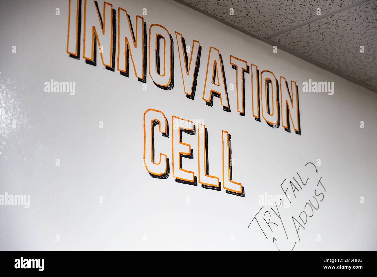 The Business Innovation Cell’s motto and title is displayed on their dry-erase wall in the 23rd Contracting Squadron at Moody Air Force Base, Georgia, March 17, 2022. The members of the cell wrote ideas and statistical information on the dry-erase wall to track and plan for future improvements in the 23rd CONS. Stock Photo