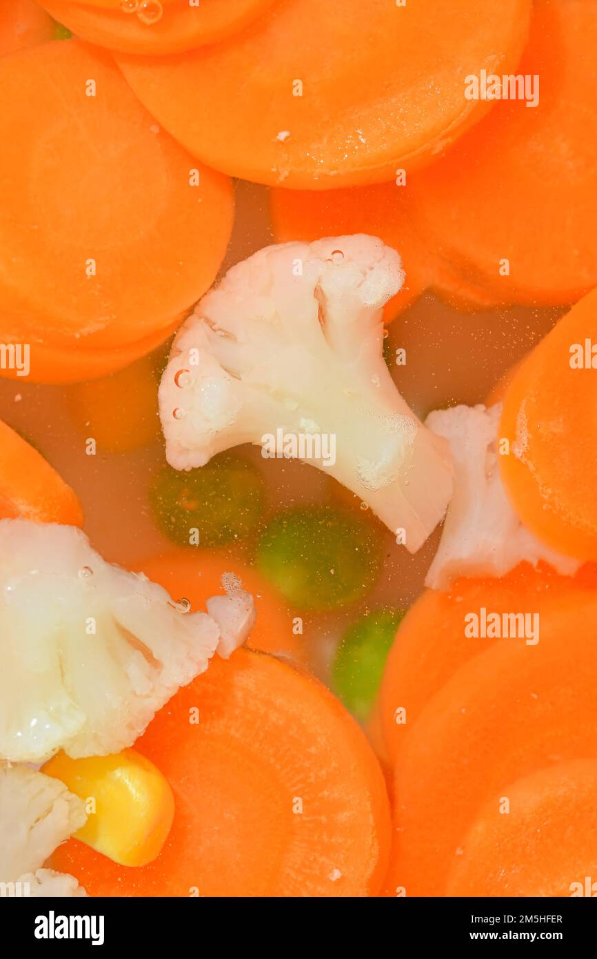 Boiling water with fresh vegetables, closeup. Closeup view of the