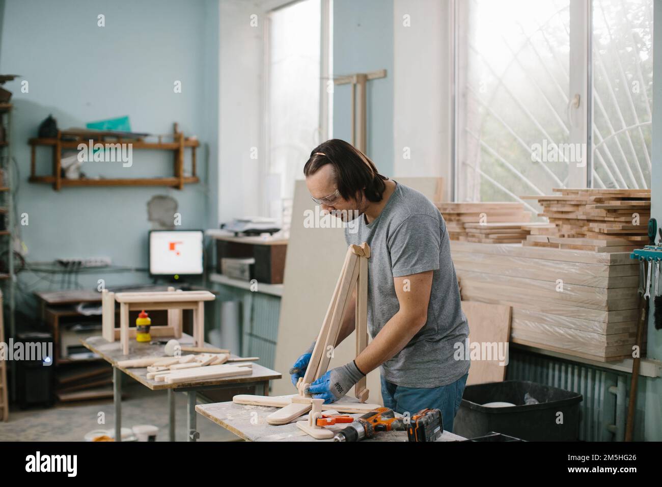 A carpenter makes wooden toys in a carpentry Making a bed