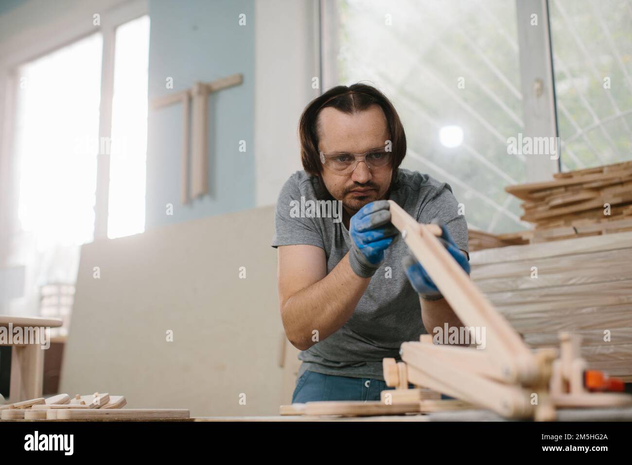 A carpenter makes wooden toys in a carpentry Making a bed