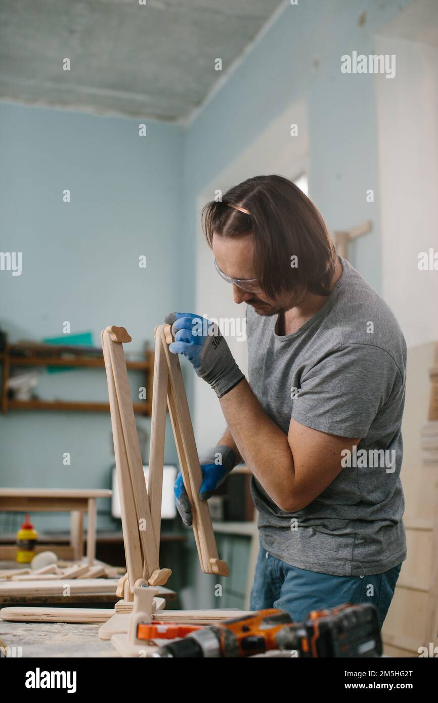 A carpenter makes wooden toys in a carpentry Making a bed
