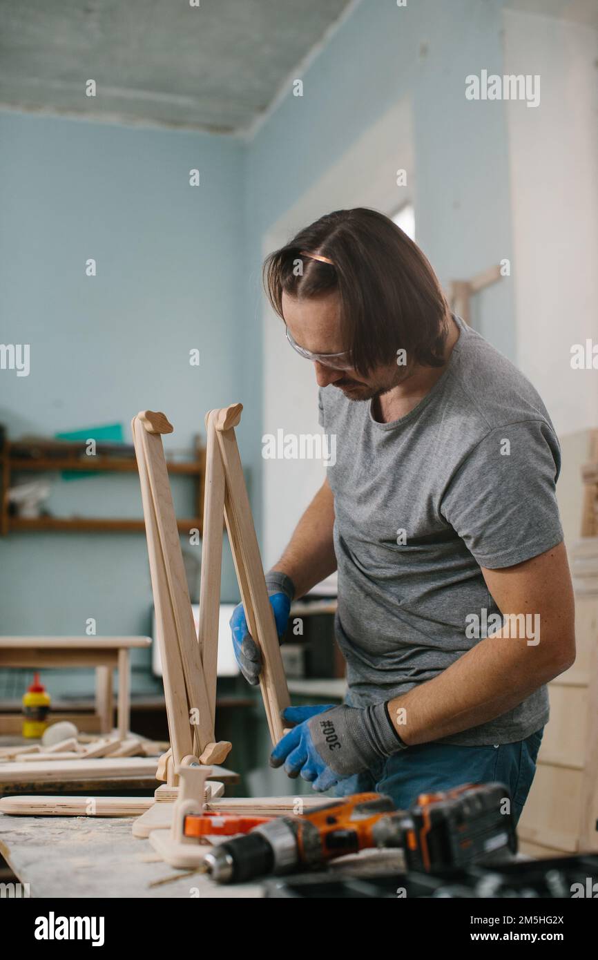A carpenter makes wooden toys in a carpentry Making a bed