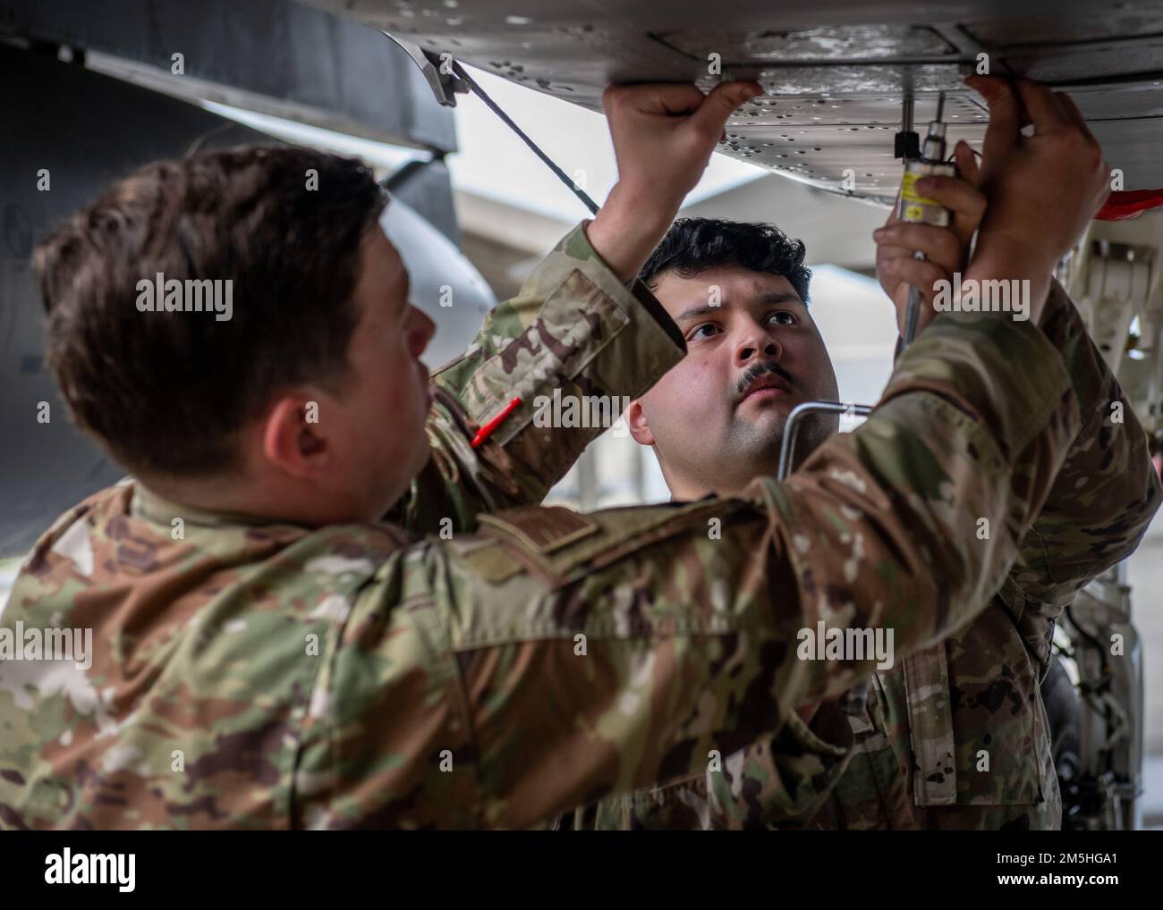 U.S. Airmen assigned to the 18th Maintenance Group install a training ...