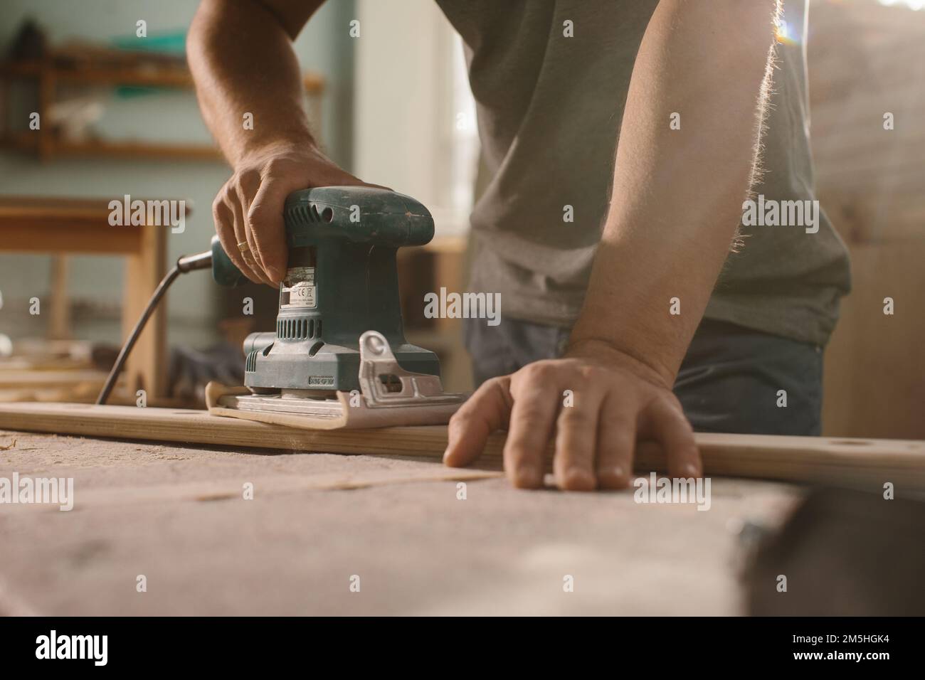 Grinding machine makes wooden polishing of bar plank Stock Photo Alamy