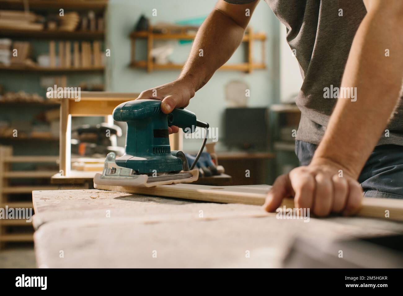Grinding machine makes wooden polishing of bar plank Stock Photo Alamy