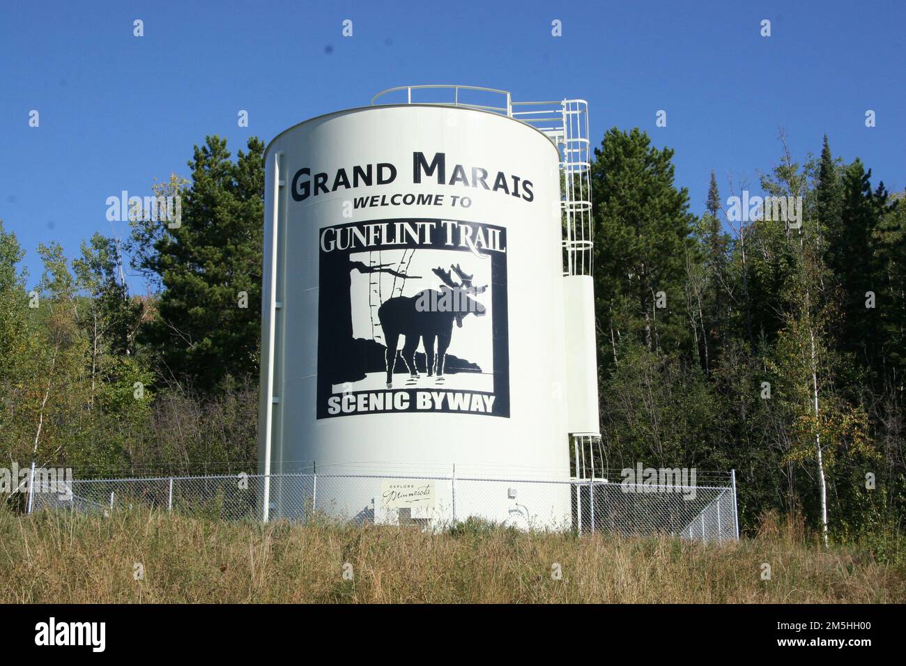 Gunflint Trail Scenic Byway - Gunflint Trail Scenic Byway Water Tower. The water tower is painted to welcome travelers to the Gunflint Trail Scenic Byway. The Scenic Byway logo pictures a moose standing on a lakeshore. Minnesota (47.763° N 90.343° W) Stock Photo