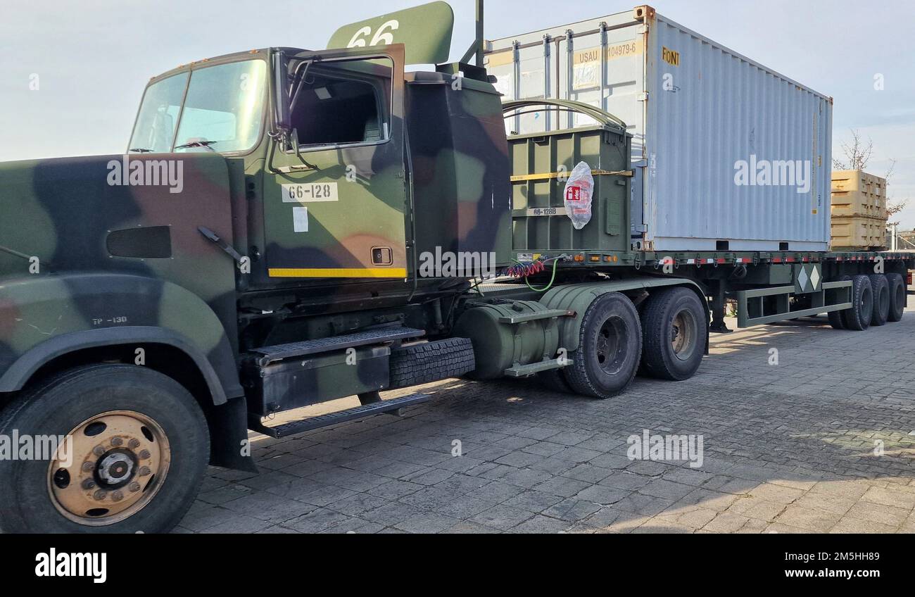 A military line-haul heavy equipment transporter, loaded with a 20-foot ...
