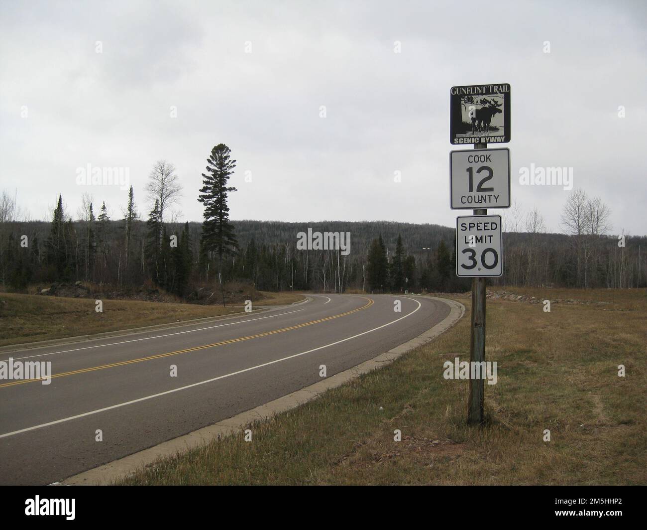 Gunflint Trail Scenic Byway - Gunflint Trail Scenic Byway Sign. One of the Gunflint Trail Scenic Byway signs tops a route marker and a speed limit sign along the byway. Minnesota (47.788° N 90.329° W) Stock Photo