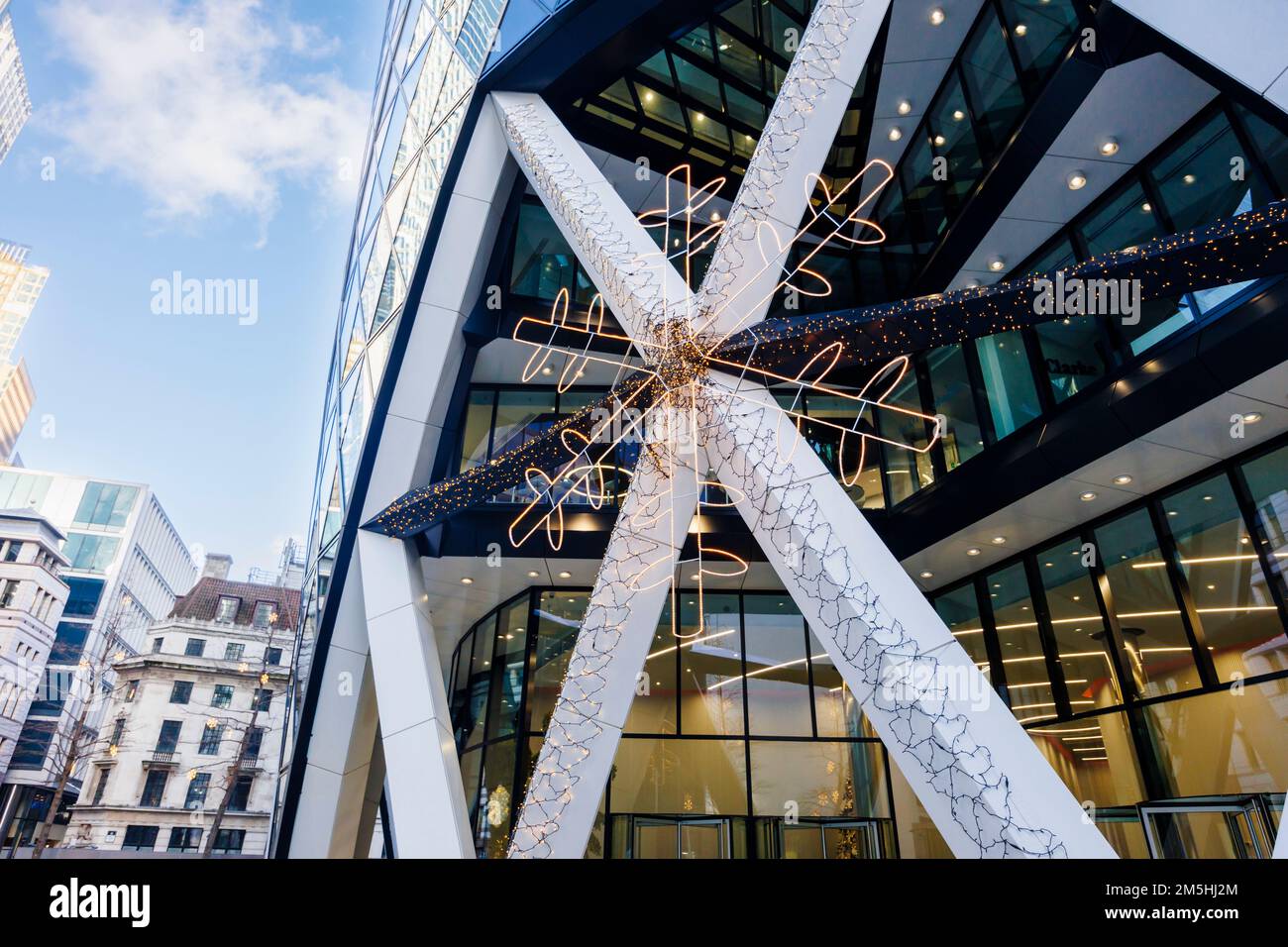 The exterior of the iconic Gherkin building in St Mary Axe in the City of London financial district, London, UK with Christmas decorative lights Stock Photo