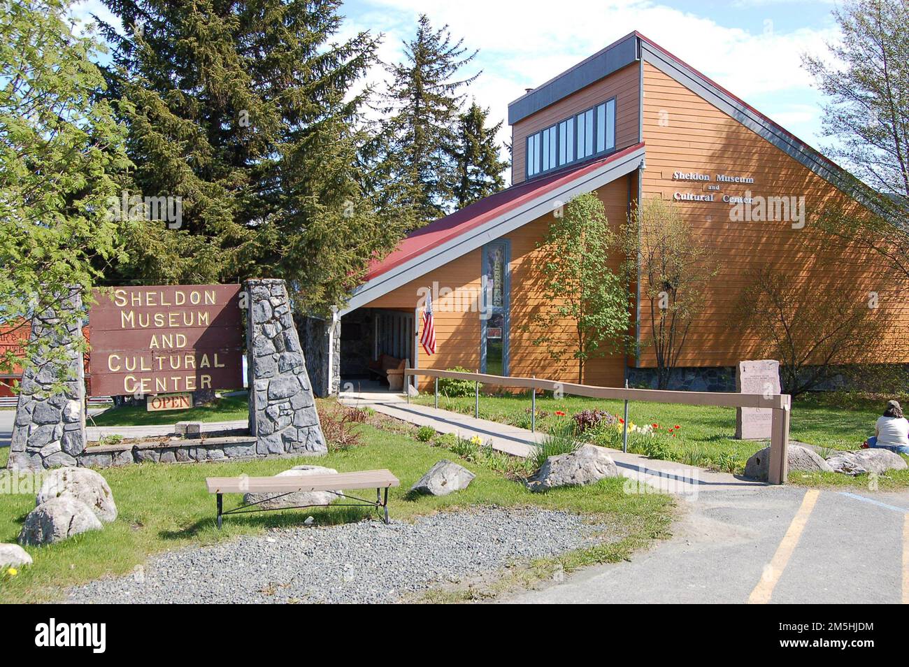 Haines Highway - Valley of the Eagles - Sheldon Museum. The Sheldon Museum and Cultural Center, on Main Street in Haines, is an orange-tan building with striking, triangular architecture. Haines, Alaska Stock Photo