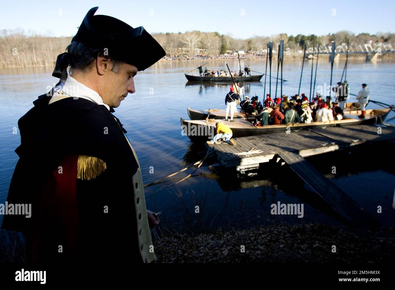 Delaware River Scenic Byway - Annual Christmas Crossing Reenactment. Durham boats full of colonial soldiers wait in the waters of the Delaware River on Christmas morning, while General George Washington contemplates the surprise attack on the Hessian's encampment at Trenton during the reenactment. Location: Trenton, New Jersey Stock Photo