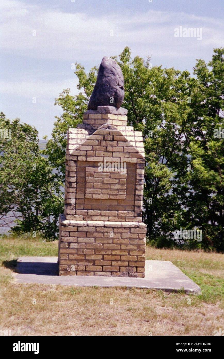 Native American Scenic Byway - Standing Rock Monument. On the east side of Fort Yates, overlooking the Oahe River, is the Standing Rock Monument. According to legend, the hunched-over rock is really the stubborn wife of a Dakota man. Location: North Dakota (45.859° N 100.462° W) Stock Photo