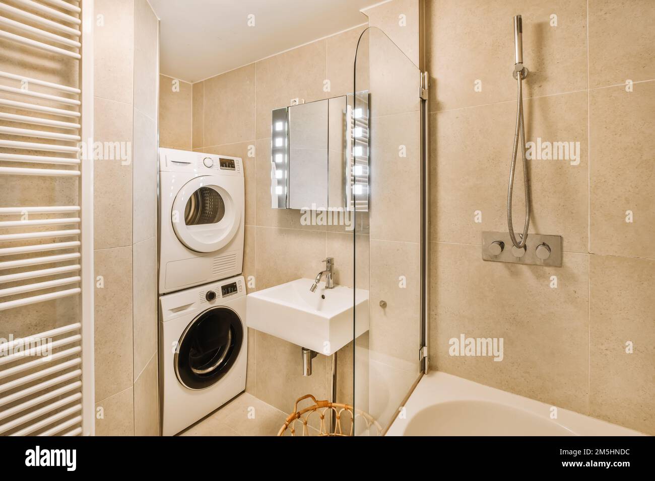 a laundry room with a washer and a bathtub in the corner, next to a