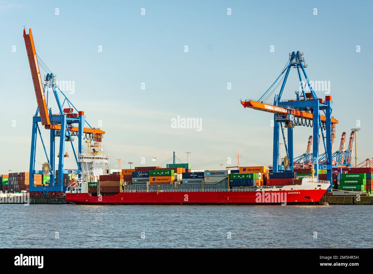 Container vessel and harbour facilities at a the Burchardkai container terminal in the port area of Hamburg, Germany Stock Photo
