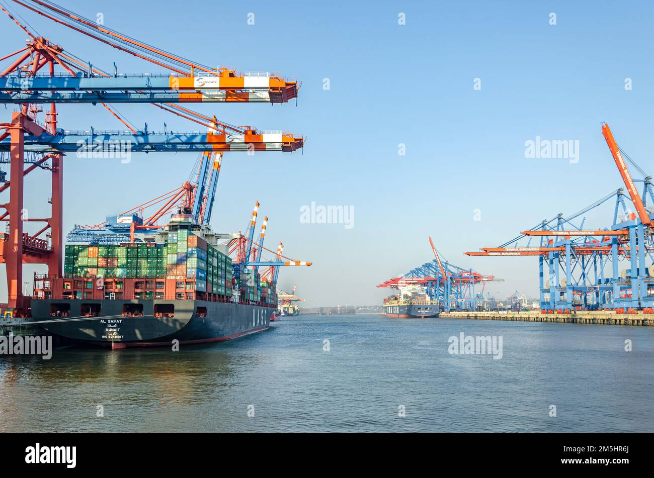 Wide shot of container vessel and harbour facilities at a the Waltershof Eurogate and Burchardkai container terminal in the port area of Hamburg, Germ Stock Photo