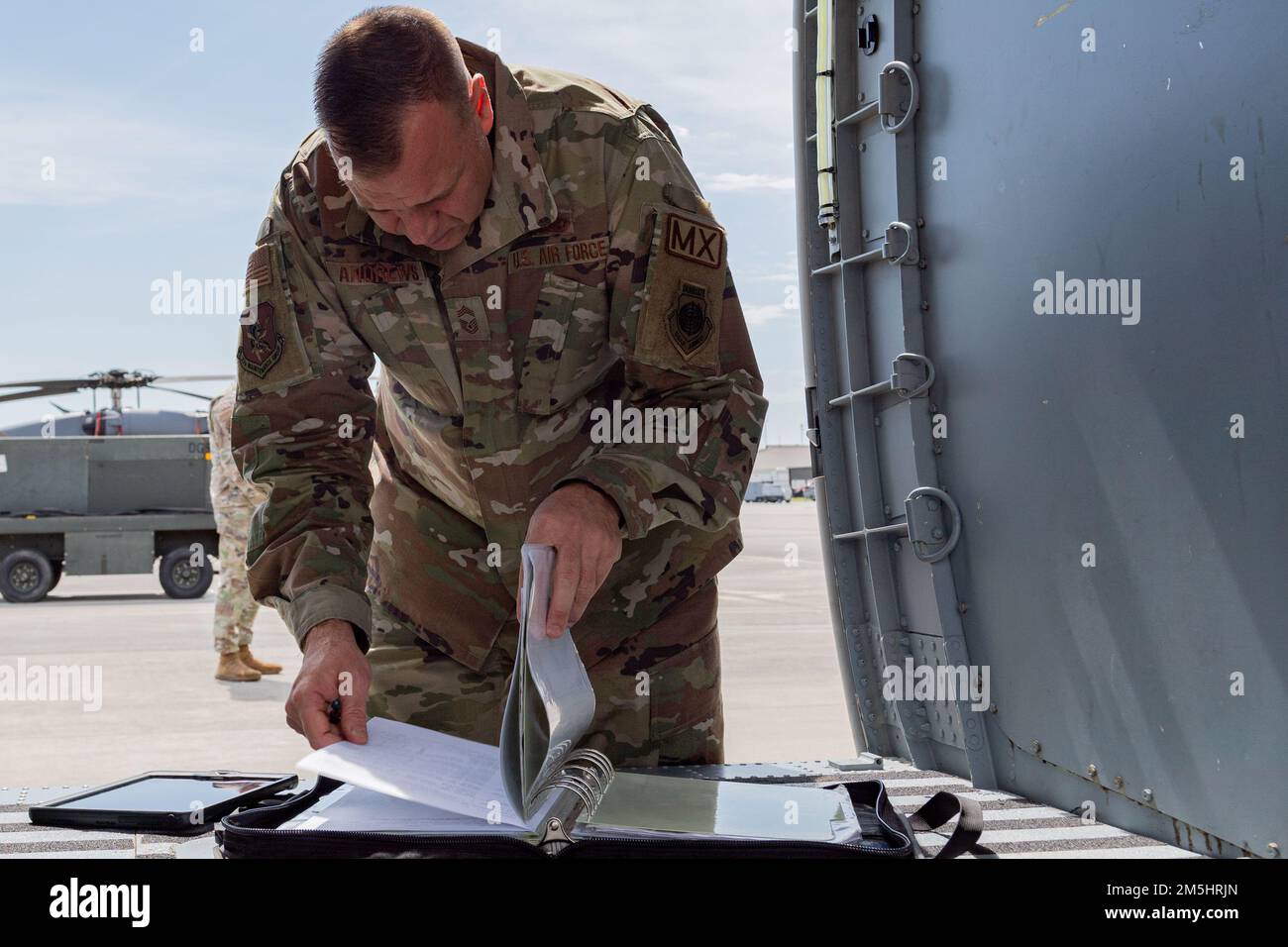 U.S. Air Force Chief Master Sgt. Shawn Andrews, 93rd Air Ground Operations Wing command chief, inspects a maintenance binder during a Top Tiger competition at Moody Air Force Base, Georgia, March 18, 2022. Maintenance binders contain tactics, techniques and procedures on how to safely and efficiently operate. Stock Photo