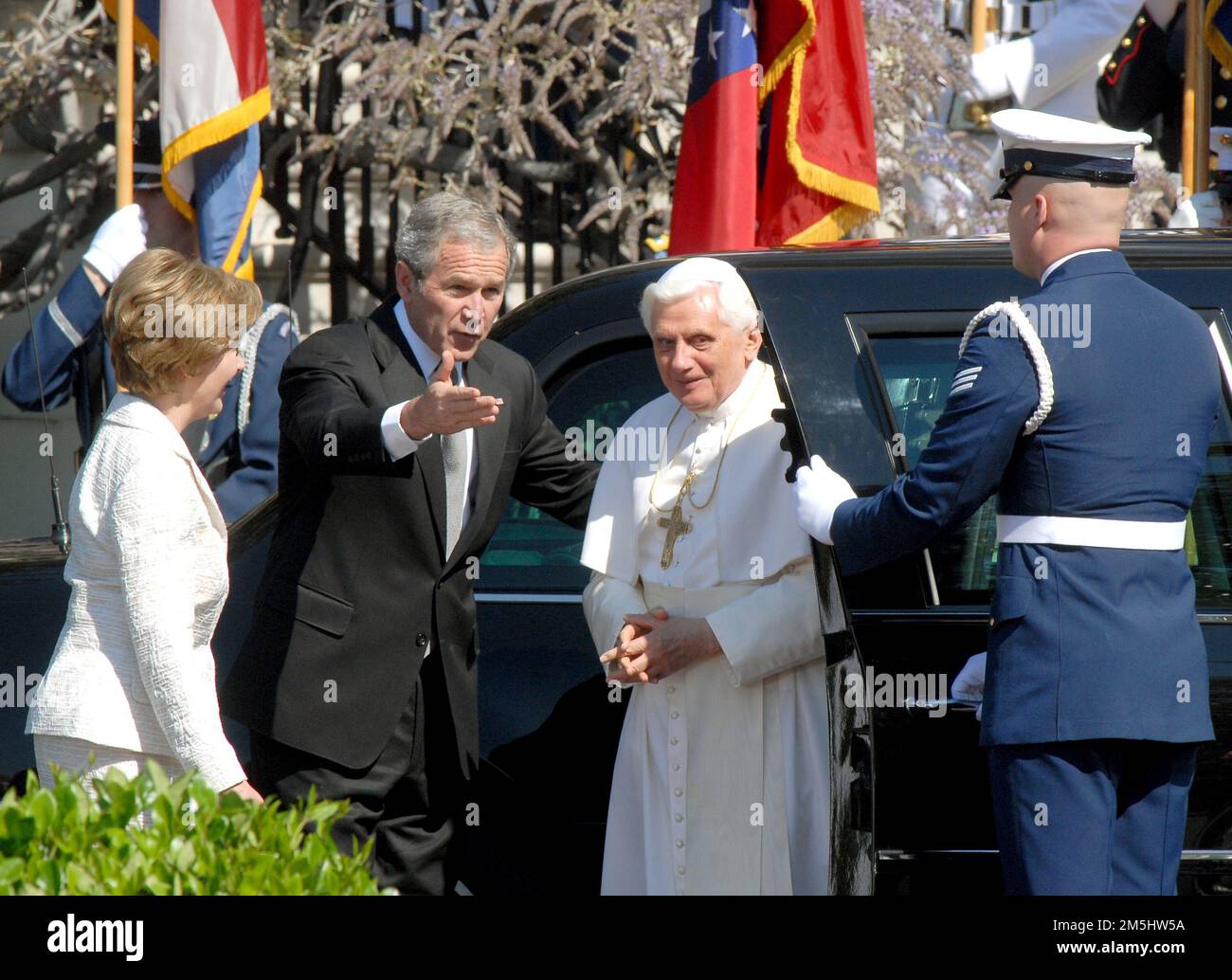 Washington, United States Of America. 16th Apr, 2008. United States President George W. Bush, center invites Pope Benedict XVI, right, towards the podium as he arrives at the White House in Washington, DC on Wednesday, April 16, 2008. First lady Laura Bush is at far left. Credit: Ron Sachs/CNP/Sipa USA.(RESTRICTION: NO New York or New Jersey Newspapers or newspapers within a 75 mile radius of New York City) Credit: Sipa USA/Alamy Live News Stock Photo
