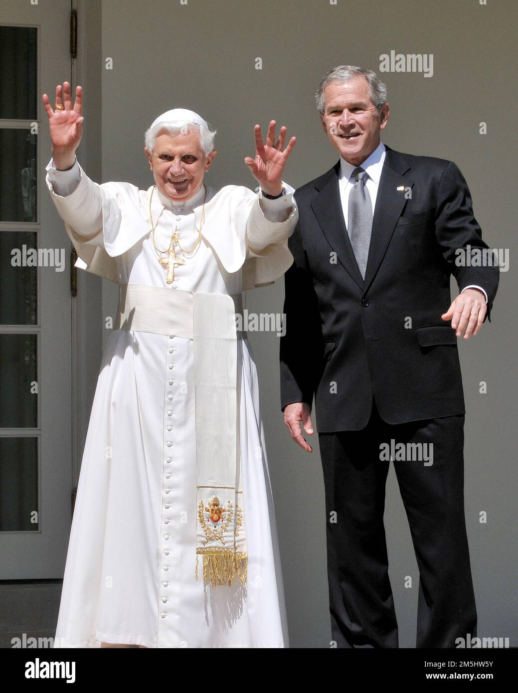 Washington, United States Of America. 16th Apr, 2008. Pope Benedict XVI raises his hands as United States President George W. Bush stop to pose for photographers as they walk along the Colonnade at the White House in Washington, DC on Wednesday, April 16, 2008. Credit: Ron Sachs/CNP/Sipa USA.(RESTRICTION: NO New York or New Jersey Newspapers or newspapers within a 75 mile radius of New York City) Credit: Sipa USA/Alamy Live News Stock Photo