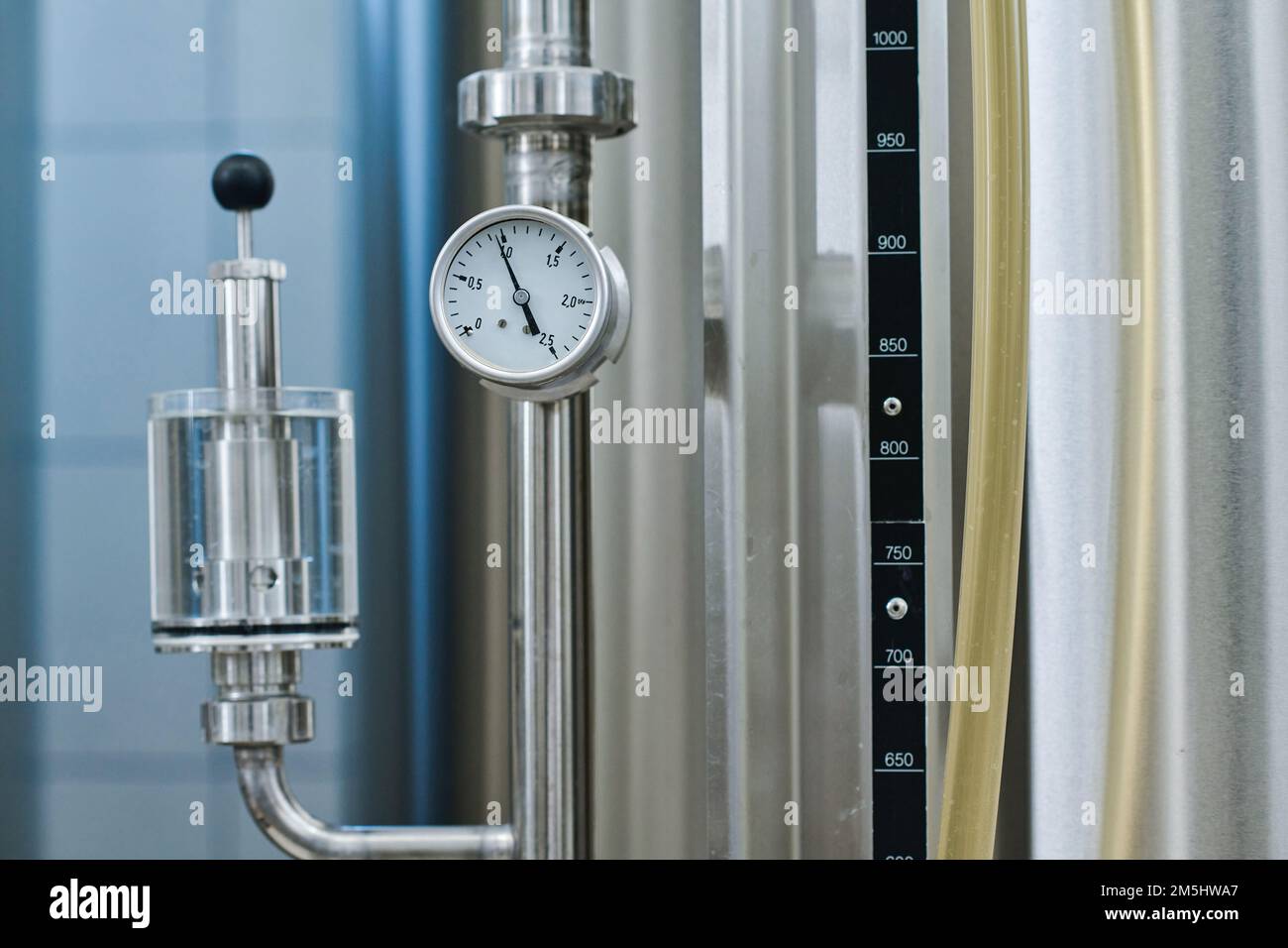 Closeup of steel storage tank with pressure gauge for controlling