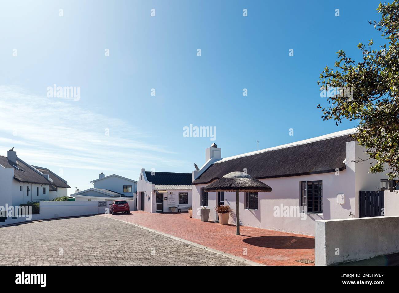 Arniston, South Africa - Sep 22, 2022: A street scene, with the reception office of Arniston Seaside Cottages, in Arniston in the Western Cape Provinc Stock Photo