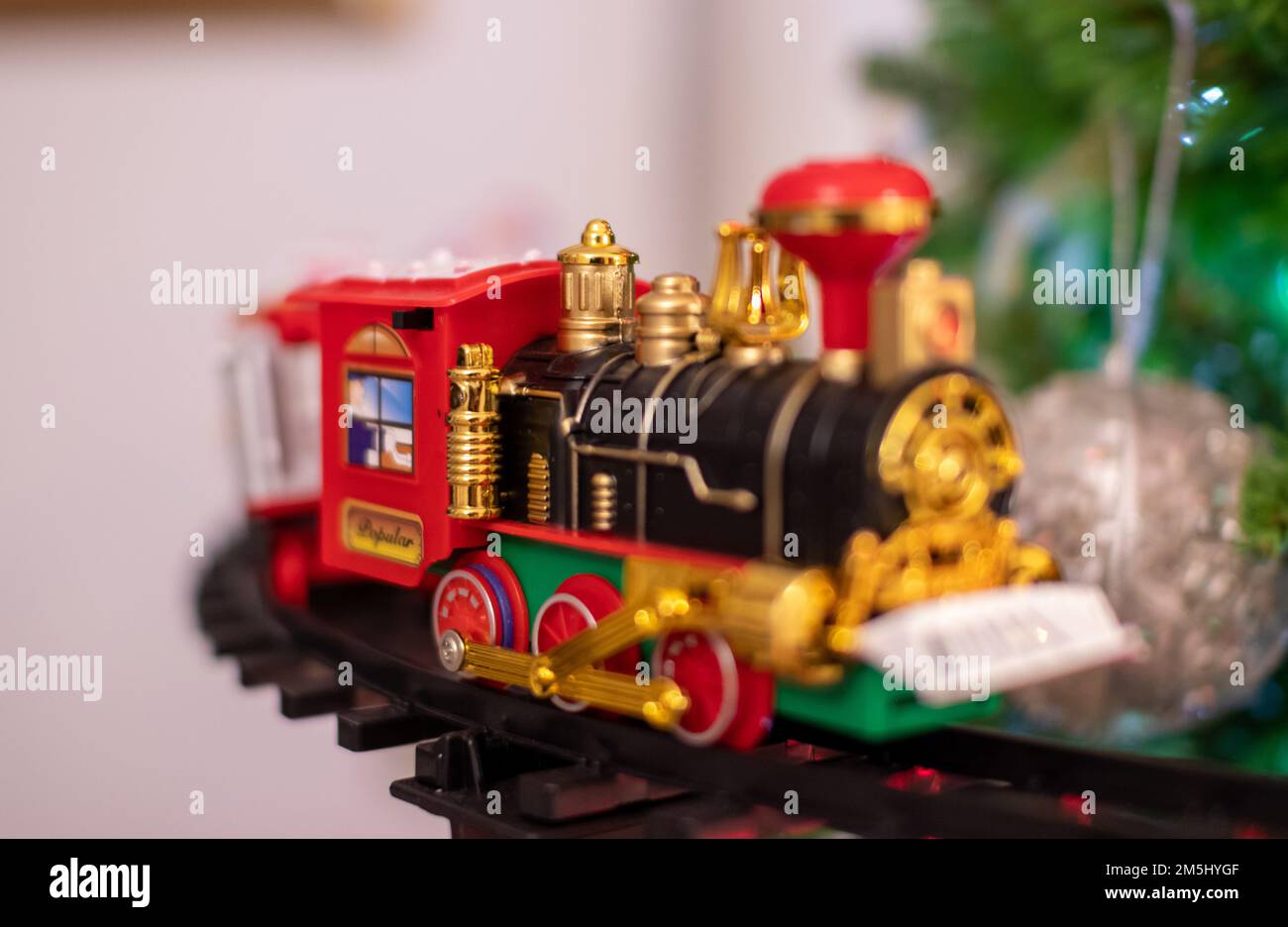 Christmas tree, a detail of the decoration. Santa's train, lights and colours. Stock Photo