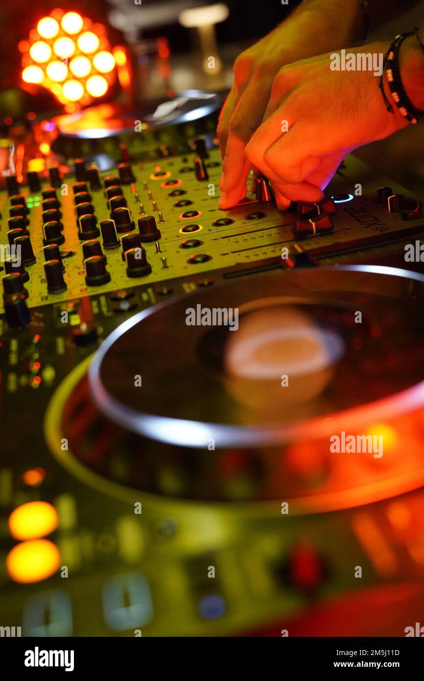 A vertical shot of a DJ turntable mixing board for electronic music and ...