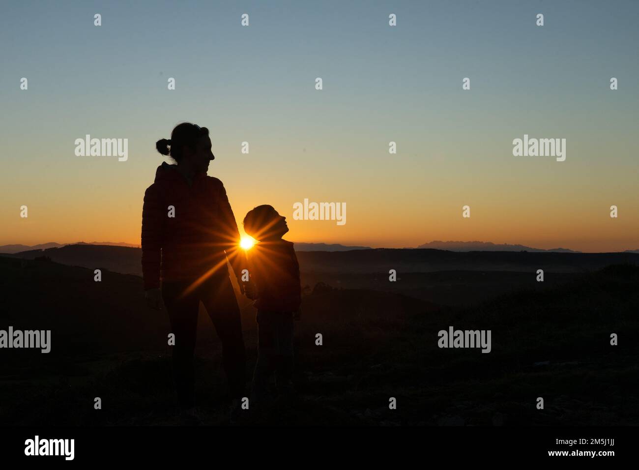 Mother and son silhouetted at sunset when walking Stock Photo - Alamy