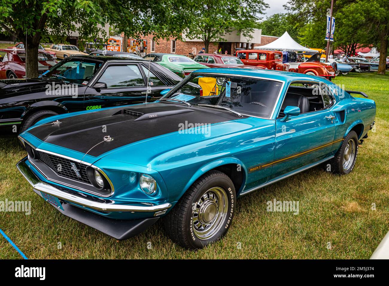 Iola, WI - July 07, 2022: High perspective front corner view of a 1969 Ford Mustang Mach 1 Fastback at a local car show. Stock Photo