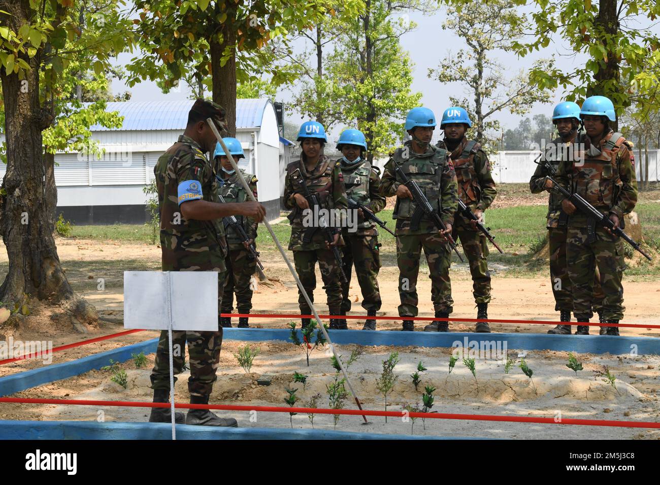 A Bangladeshi instructor instructs soldiers on improvised explosive device (IED) maneuvers during Exercise Tiger Lightning 2022 March 19, 2022 at Bangladesh Institute of Peace Support Operation Training center in Dhaka, Bangladesh. TL22 is a bilateral exercise sponsored by U.S. Indo-Pacific Command and hosted by the Bangladesh Armed Forces, strengthening Bangladesh defense readiness, building operational interoperability, and reinforcing partnership between the Bangladesh Armed Forces and the Oregon National Guard. (Air National Guard photo by Master Sgt. Aaron Perkins, Oregon Military Departm Stock Photo