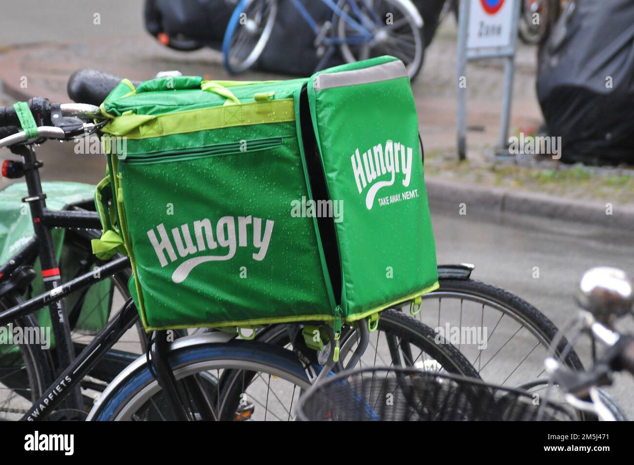 Copenhagen/Denmark/29 December 2022/ Hungry food delivery biker in