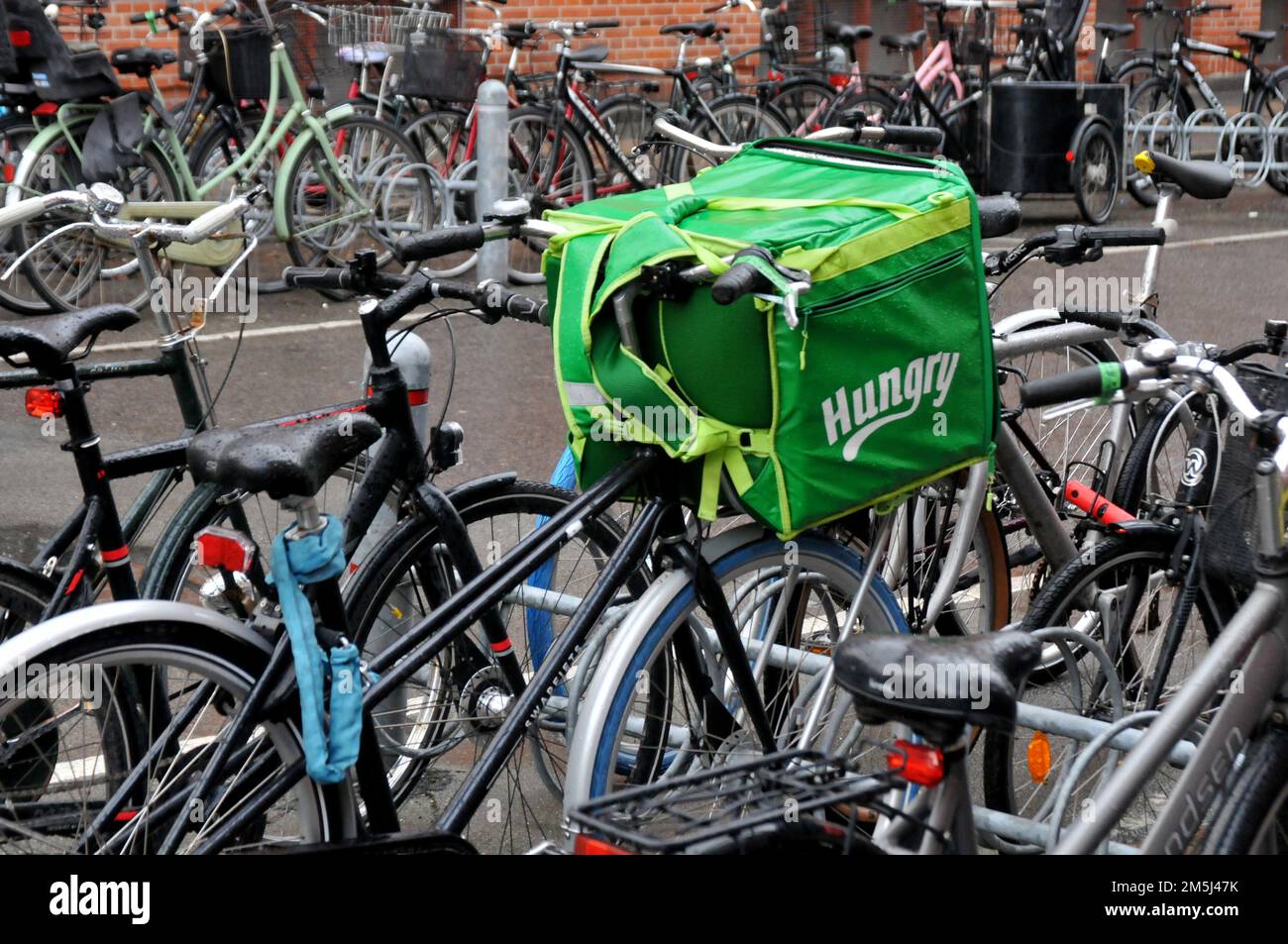 Copenhagen/Denmark/29 December 2022/ Hungry food delivery biker in