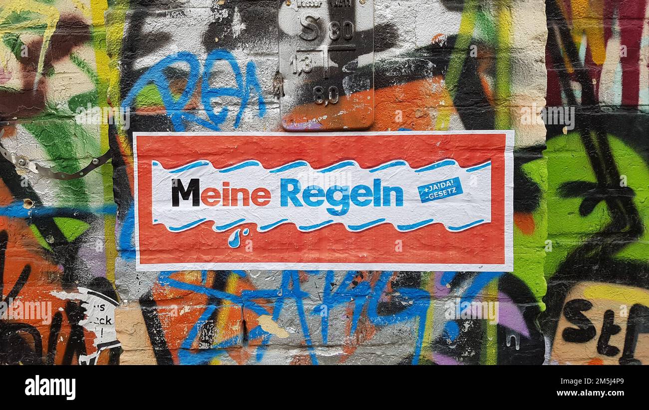 A background of Berlin street art graffiti with Meine Regeln sign painted Stock Photo
