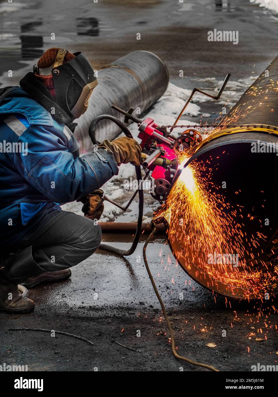 Working welder cuts metal and sparks fly. Gas cutting of large diameter