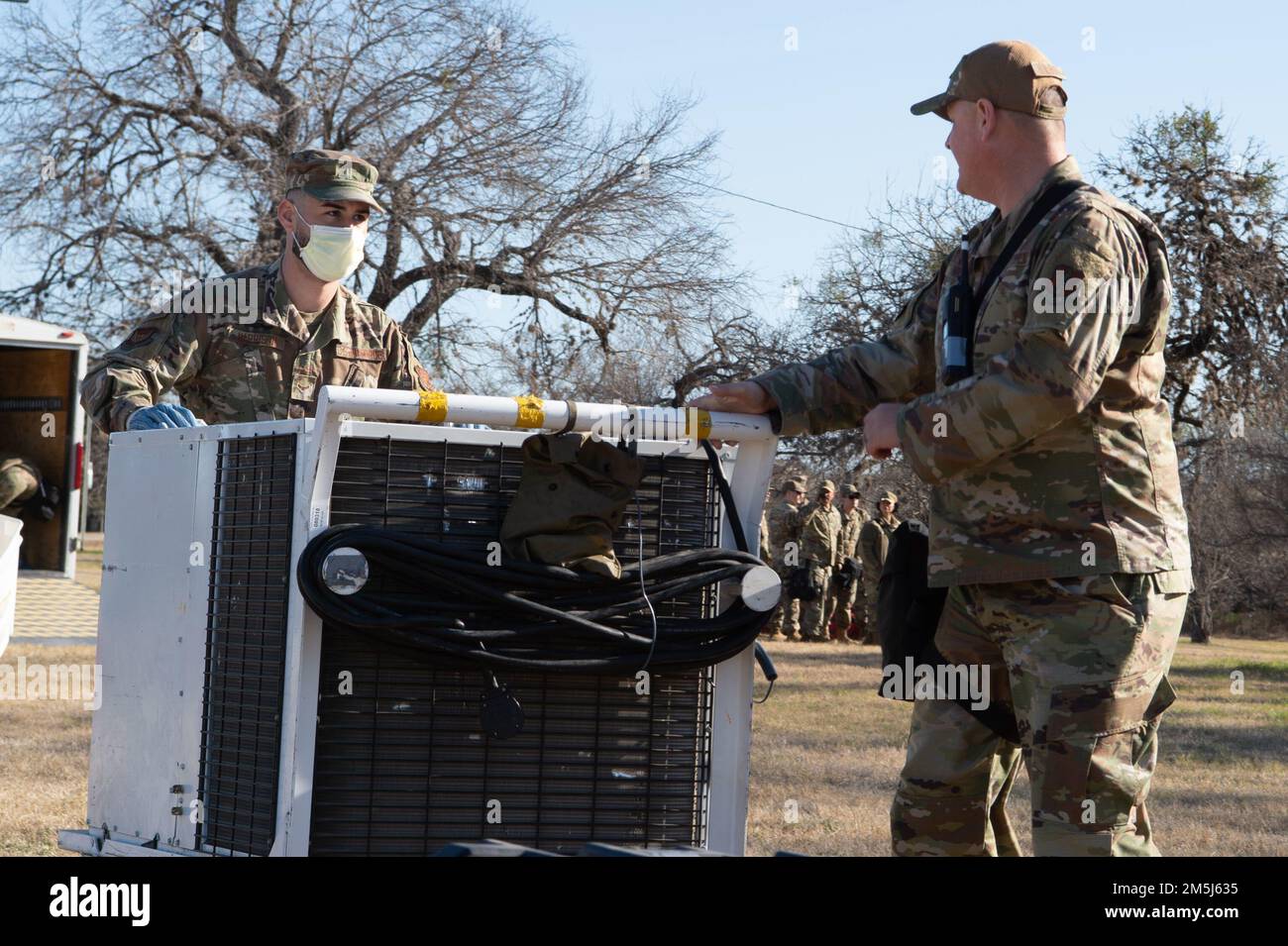 Lt. Col. James Wilburn, 149th Fighter Wing Medical Group Detachment 1 Commander and A1C Kristopher Harrison, aerospace medical technician, transport electrical generators to set up power during the 149th's MDG CERFP training. Stock Photo