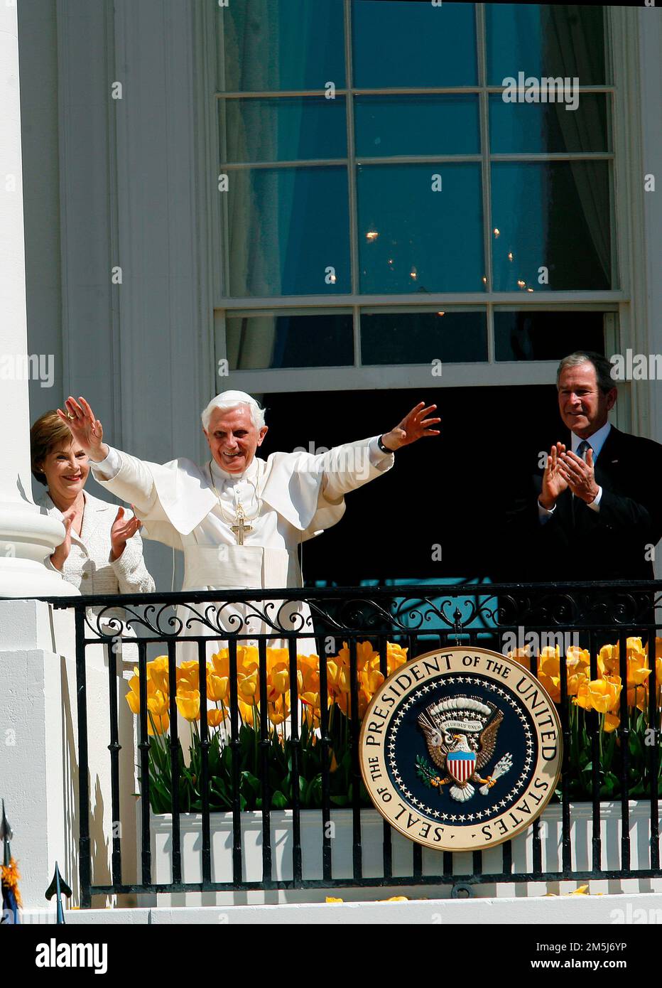 Pope Benedict XVI, center, blesses the crowd from the Blue Room Balcony at the end of the Arrival Ceremony in his honor hosted by United States President George W. Bush, right and first lady Laura Bush, left, on the South Lawn of the White House, Washington DC April 16, 2008.. Credit: Aude Guerrucci / Pool via CNP / MediaPunch Stock Photo
